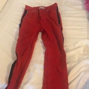Red Zara jeans with a black stripe on each side